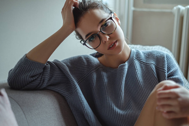 Beautiful girl with glasses looking into a camera - Zdjęcie, obraz