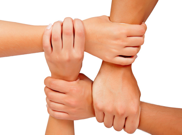 four hands together, symbol of team work, isolated on white background - Photo, image