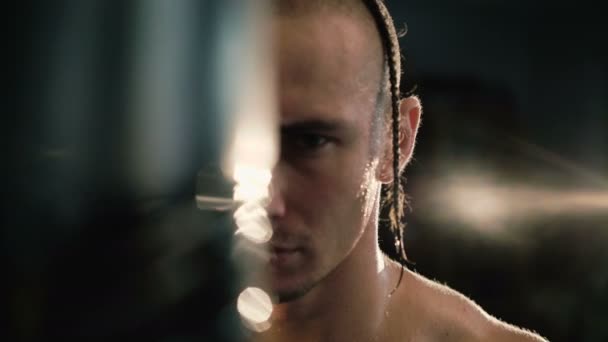 Portrait of hairless with pigtail and tattoos, free fighter at punching bag 4K - Filmagem, Vídeo