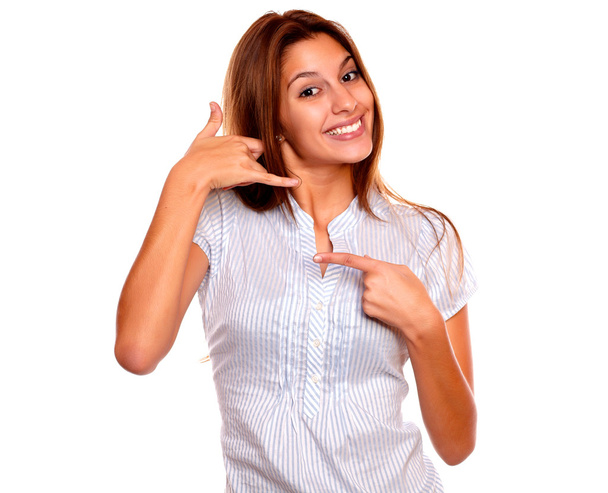 Smiling young woman pointing and saying call me - Foto, afbeelding
