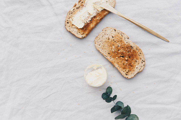 Flat Lay Slice of white buttered toast on a plate. Breakfast concept  - Fotoğraf, Görsel
