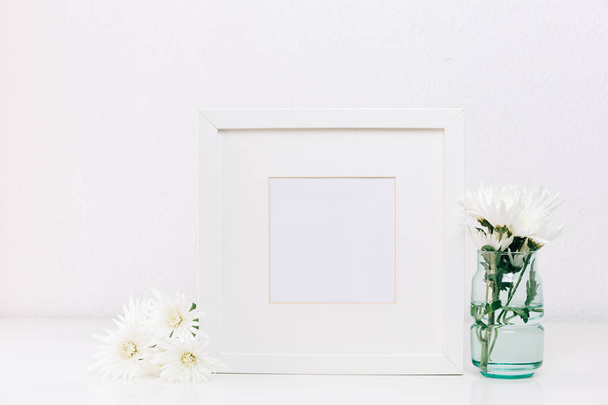 Mock up white frame with spring flowers. Minimal design template - Photo, image