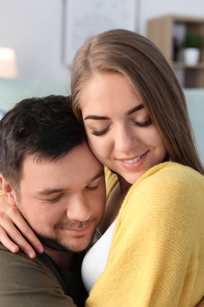Cute young lovely couple hugging at home - Fotografie, Obrázek