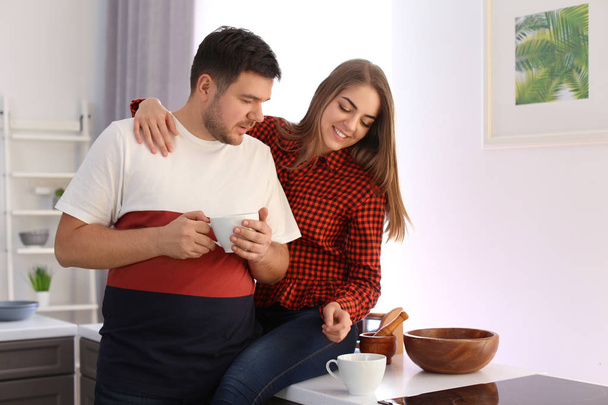 Cute young lovely couple drinking tea at home - Foto, Bild