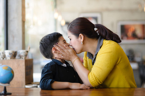 Asian mother kissing her son, lifestyle concept. - Φωτογραφία, εικόνα