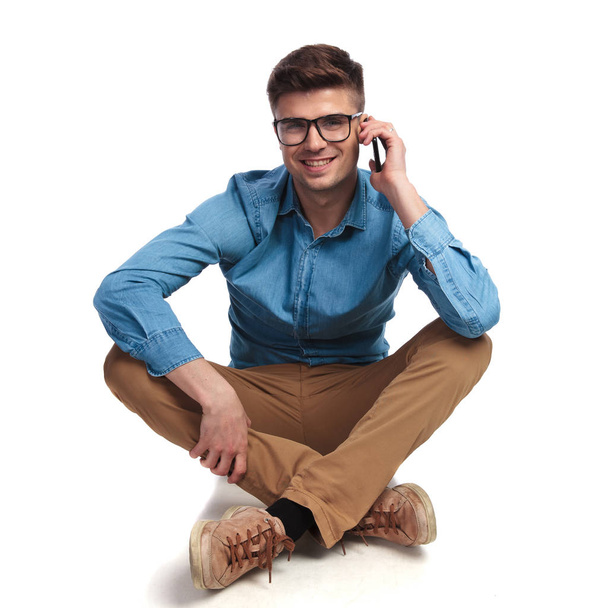 casual man sits  and talks on the phone  - Photo, Image