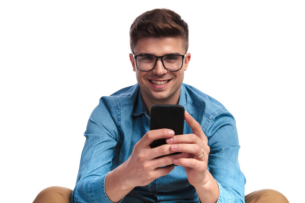 laughing casual man texting on his smart phone - Fotó, kép