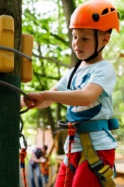 Хлопчик піднімається на мотузковий парк
 - Фото, зображення
