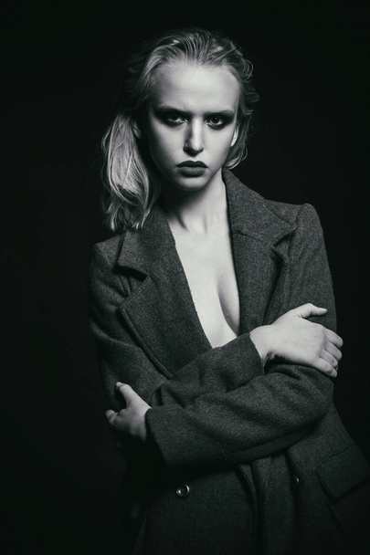 Blond woman wearing black coat - Valokuva, kuva