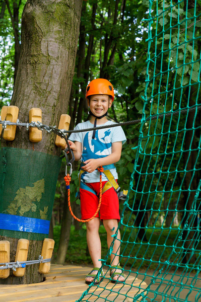 The boy climbs a pendant park - Photo, Image