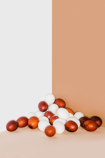 painted and white chicken eggs on minimalistic background - Photo, Image
