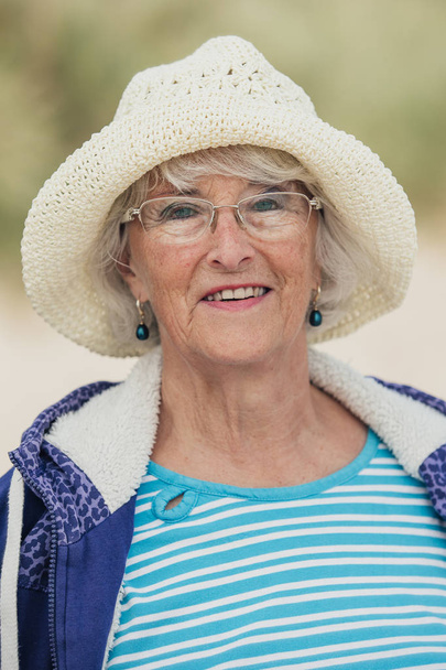 Elderly Woman Smiling at the Beach - Valokuva, kuva
