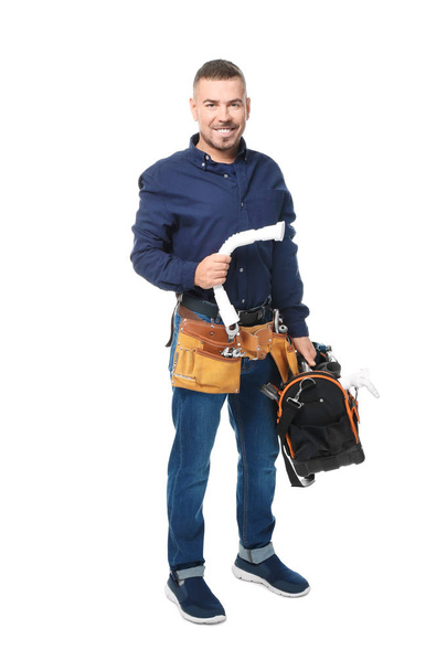 Plumber with tools and plastic pipe on white background - Foto, Imagem
