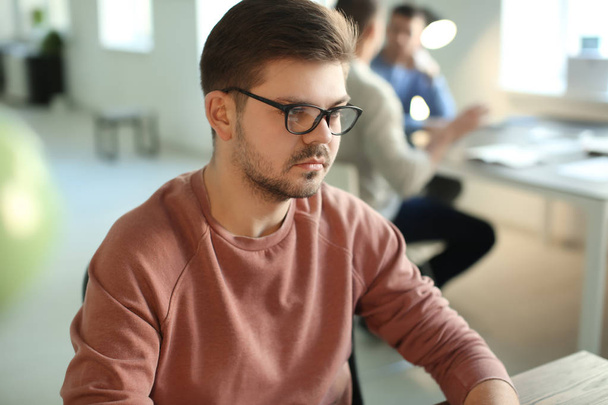 Young man working in office - Foto, afbeelding