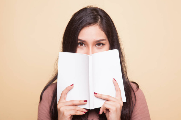 Young Asian woman with a book. - 写真・画像