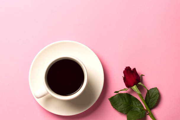 Morning concept background with rose and a cup of coffee. Top view with space for your text - Photo, Image