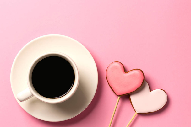 Valentine day background with gingerbread hearts and a cup of coffee, top view with space for your text - Foto, Imagen