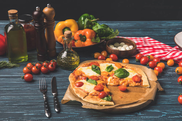 appetizing tasty pizza on cutting board on tabletop - Photo, image