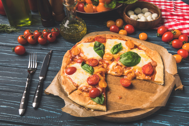 appetizing tasty pizza on cutting board on table - Fotografie, Obrázek