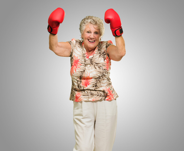 Happy Mature Woman Wearing Boxing Glove - Photo, image