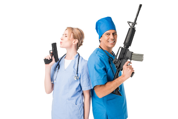 Smiling male doctor and nurse with guns isolated on white - Photo, Image