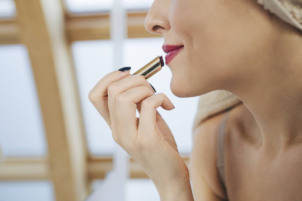Woman Putting Lipstick - Фото, изображение