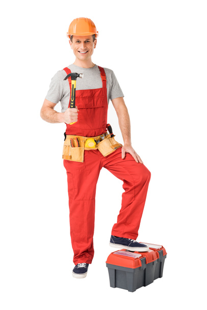 Cheerful construction worker holding hammer isolated on white - Photo, Image