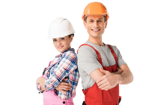 Чоловіки і жінки будівельники в твердих капелюхах і комбінезоні ізольовані на білому
 - Фото, зображення