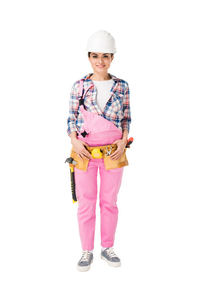 Trabalhadora da construção feminina alegre em uniforme rosa isolado em branco
 - Foto, Imagem
