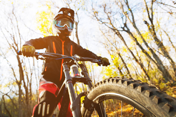 Портрет молодого всадника в полной защите шлема и перчаток на велосипеде
 - Фото, изображение