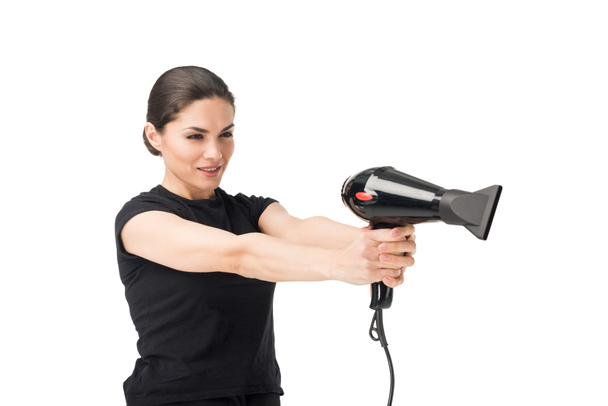 Woman hairdresser aiming with hairdryer isolated on white - Valokuva, kuva