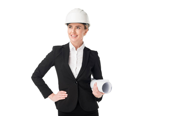 Female construction engineer in suit holding blueprint isolated on white - Photo, Image