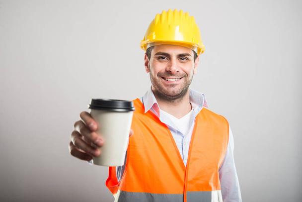 Portrait of architect offering takeaway coffee cup - Φωτογραφία, εικόνα