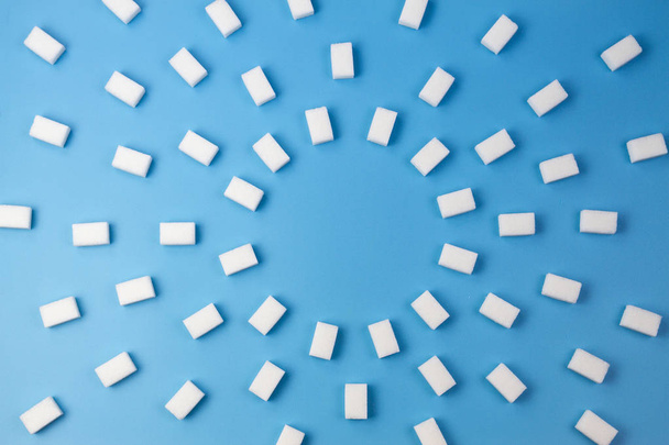 кубики белого сахара на синем фоне - Фото, изображение