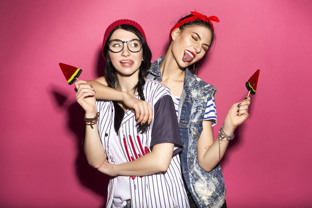 Two caucasian brunette hipster woman in casual stylish outfit ha - 写真・画像
