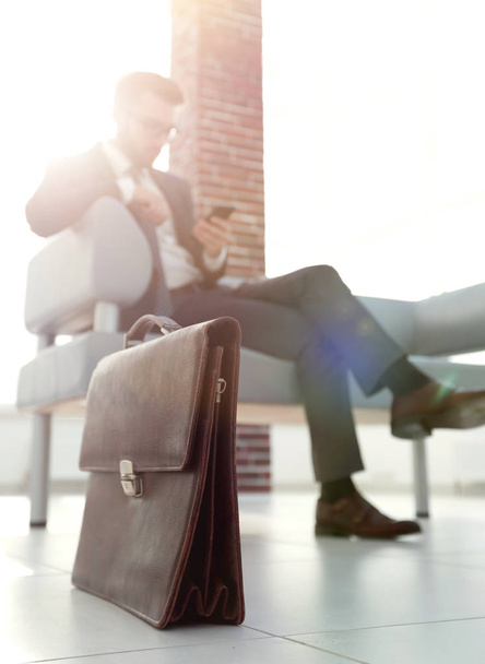 Businessman sitting on sofa in the office - Фото, изображение