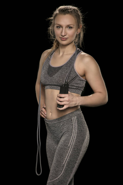 beautiful athletic girl is practicing with a skipping rope, isol - Foto, Imagen