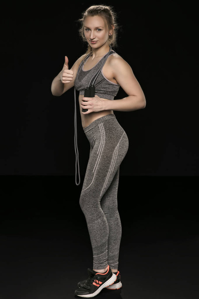 beautiful athletic girl is practicing with a skipping rope, isol - Foto, immagini