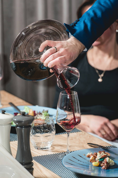 sommelier pouring champagne into glass at wine tasting - Zdjęcie, obraz
