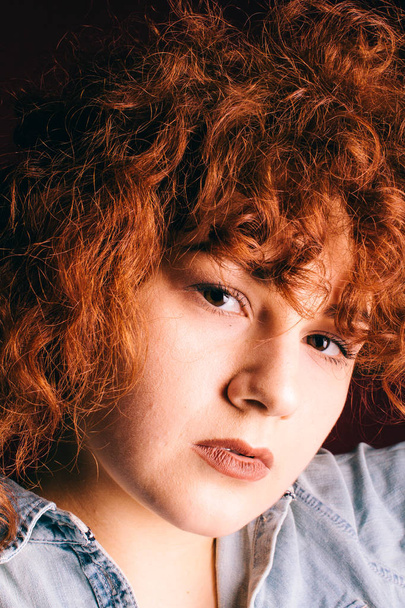 Portrait of a beautiful girl with curly red hair - Foto, imagen