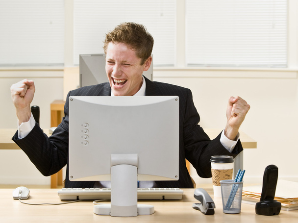 Businessman cheering at Desk - Foto, imagen