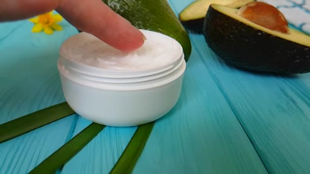hand cream cosmetic avocado on blue wooden - Footage, Video