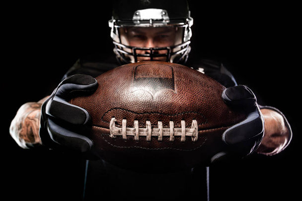 American football sportsman player isolated on black background - Фото, изображение