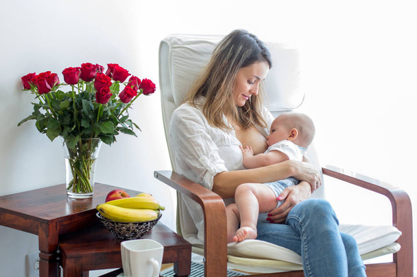 Mother, playing with her toddler boy, breastfeeding him - Zdjęcie, obraz