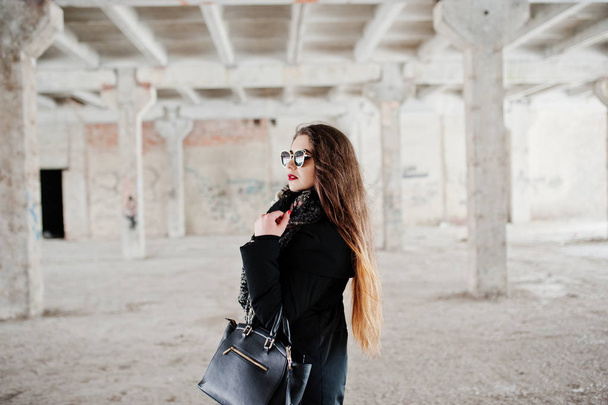 Brunette stylish casual girl in scarf and handbag against abando - Foto, afbeelding