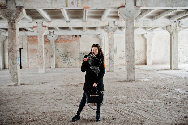 Brunette stylish casual girl in scarf and handbag against abando - Fotó, kép