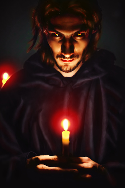 evil sorcerer with a candle - Photo, Image