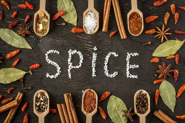 Various spices in wooden spoons  on dark  table - Photo, Image