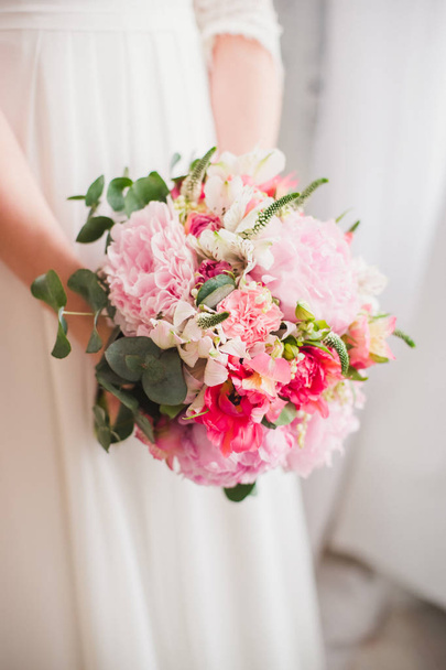 close-up of female hands holding beautiful wedding bouquet of colored flowers - Fotoğraf, Görsel
