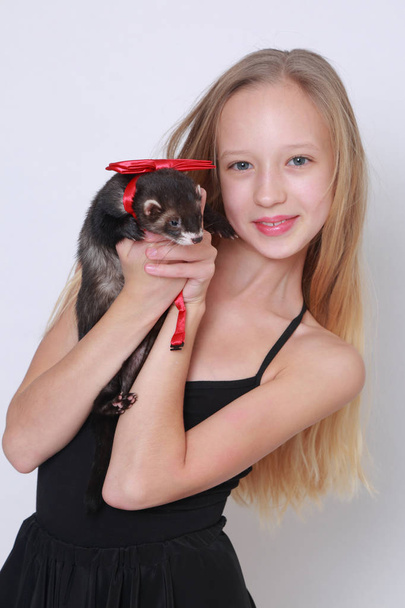 Studio image of caucasian little girl and ferret over white backgoud - Photo, Image